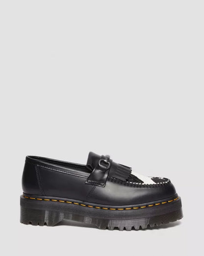 A black Adrian Snaffle Platform Loafer with cow print detail on a white background.