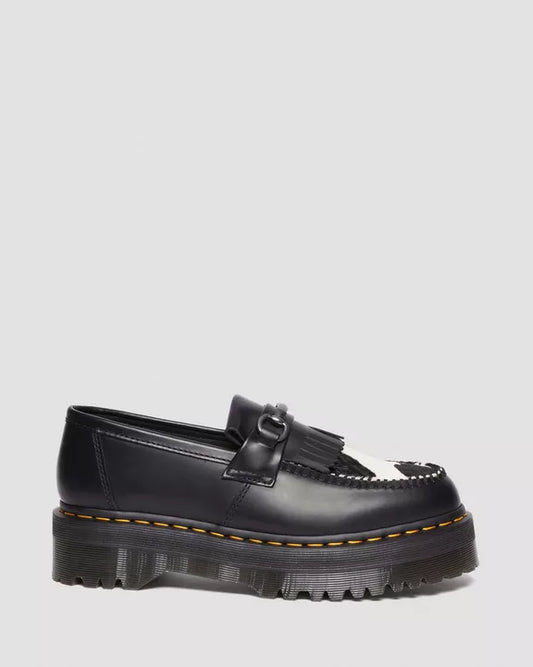 A black Adrian Snaffle Platform Loafer with cow print detail on a white background.