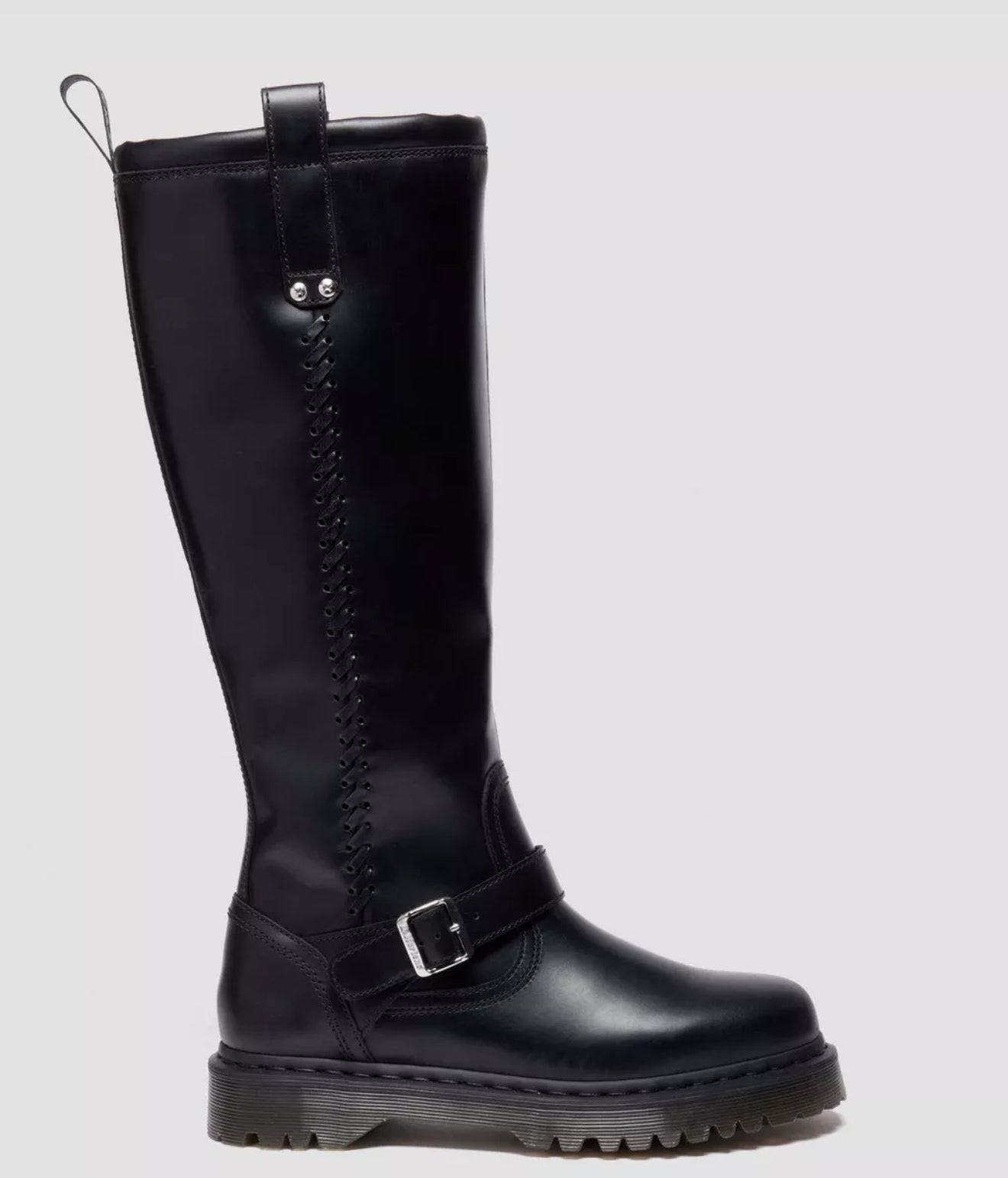 Black knee-high boot with a buckle on a light gray background