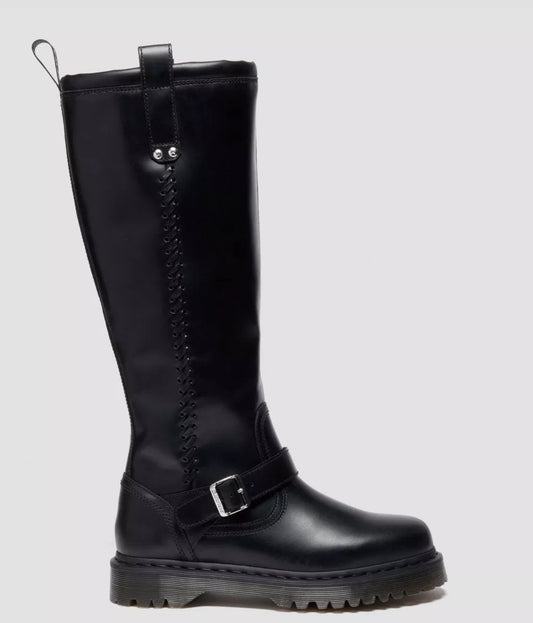 Black knee-high boot with a buckle on a light gray background