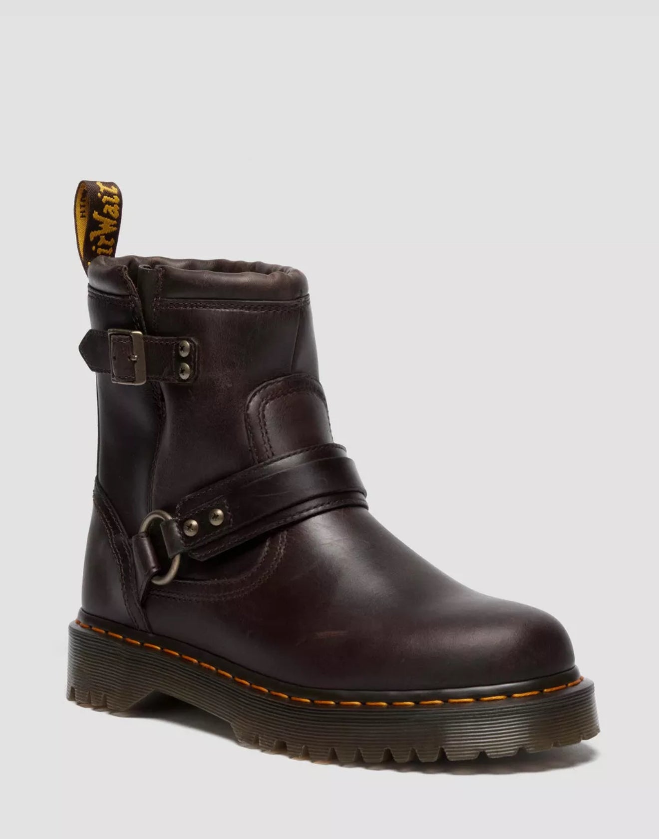 Brown leather boot with buckle on a light gray background