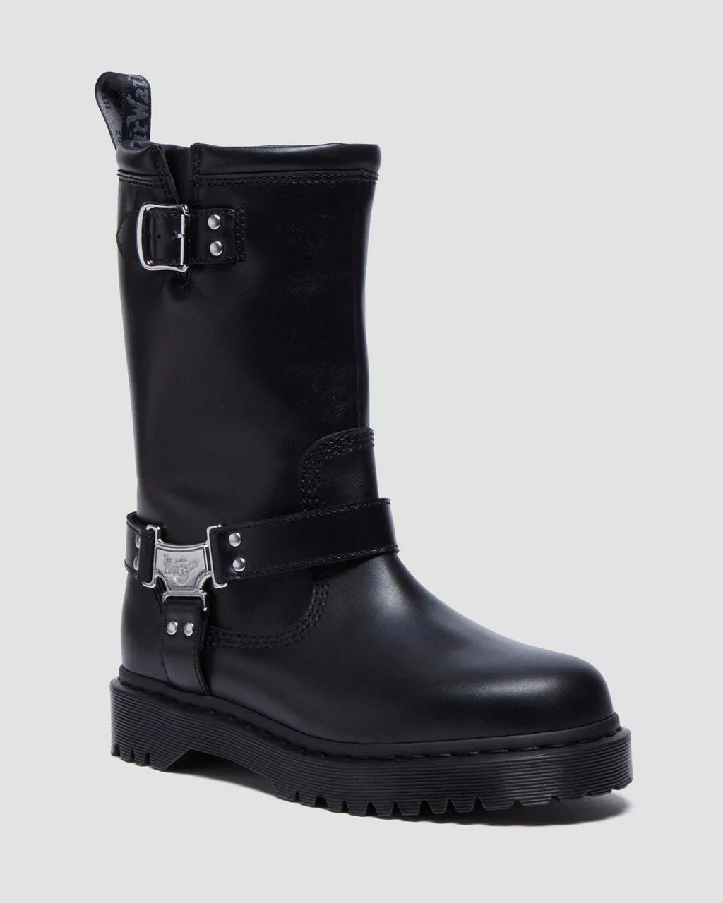 Black leather boot with buckles on a light gray background
