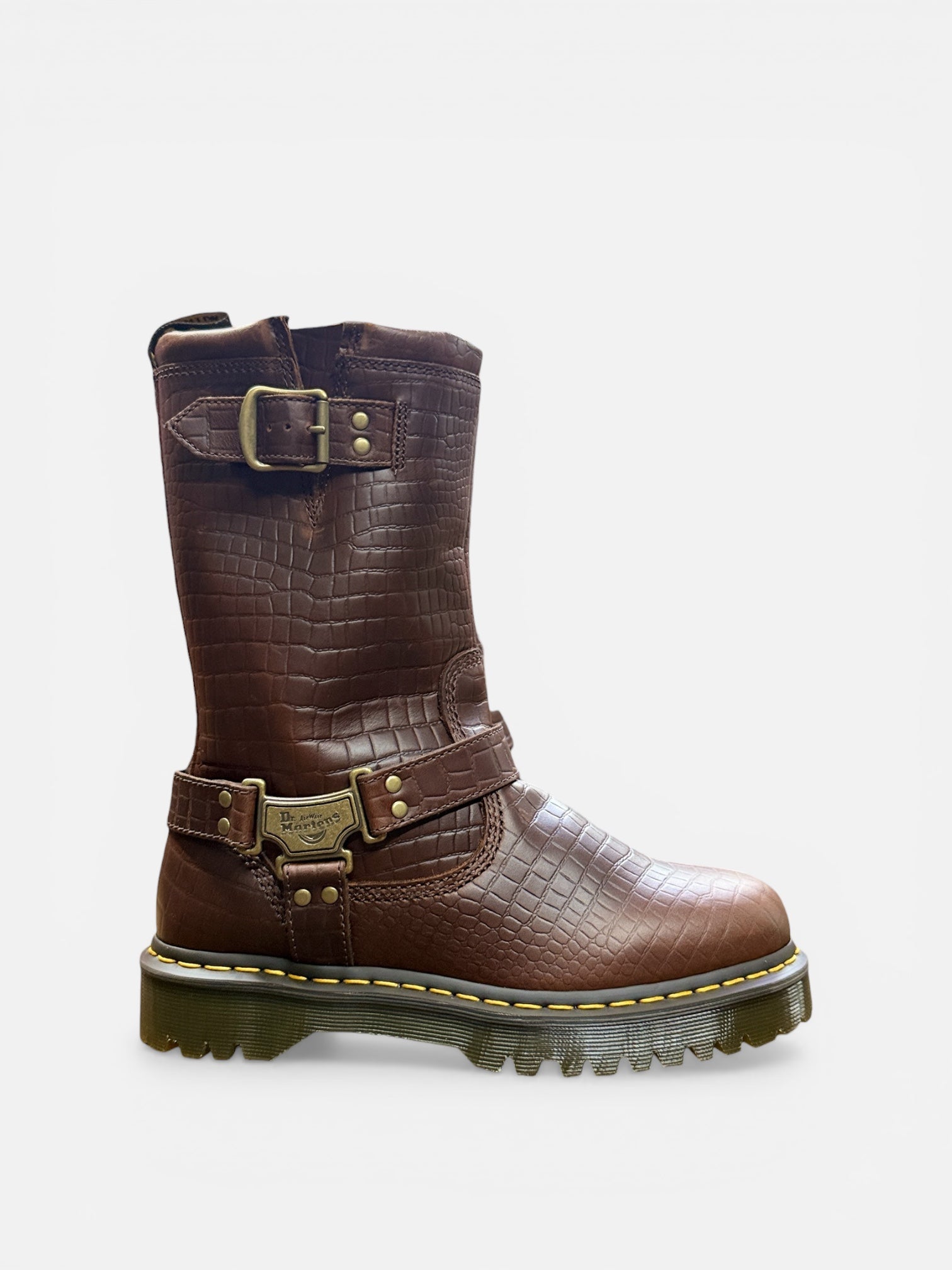 Brown leather boot with gold buckles on a white background