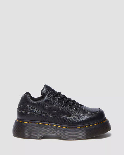 A brown Buzz 5-eye shoe with a lace-up closure and a thick sole.