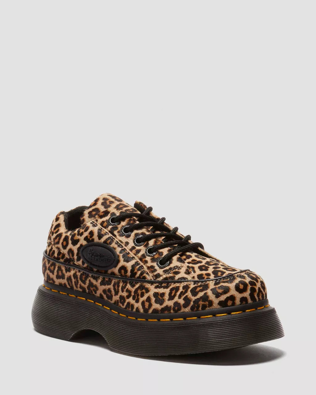 Leopard print sneaker with black sole on a light gray background