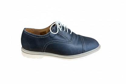 Blue leather shoe with white laces on a white background