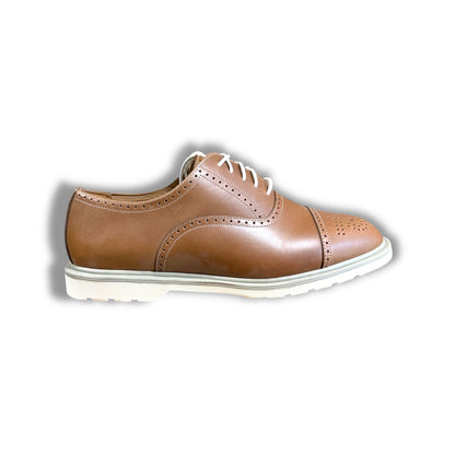Brown leather shoe with white sole on a white background