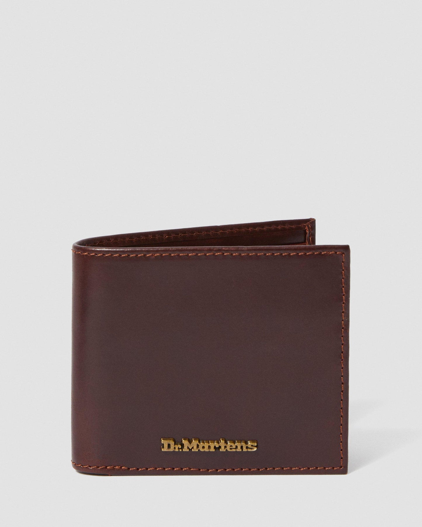A brown Dr. Martens leather wallet with multiple card slots and metal branding on the front.