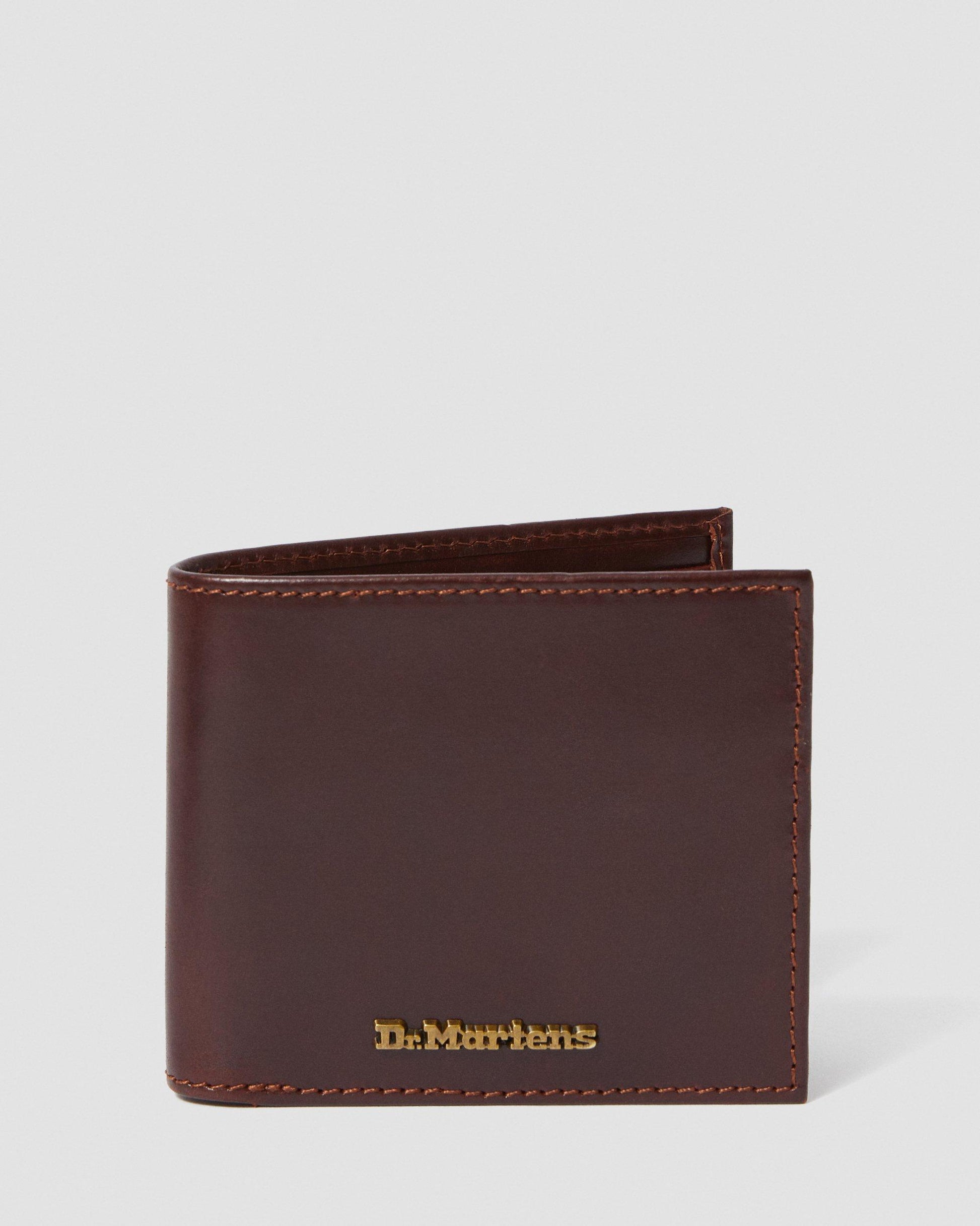 A brown Dr. Martens leather wallet with multiple card slots and metal branding on the front.