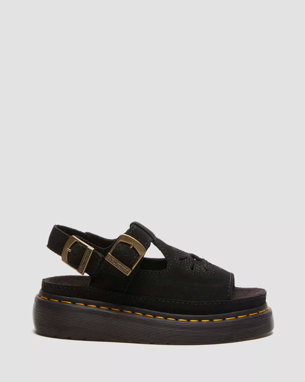 Black leather sandals with floral design and buckle straps.