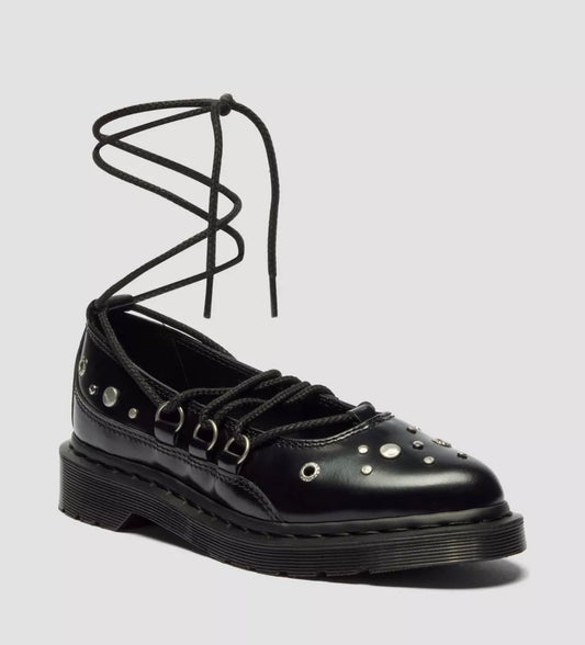 Black leather shoe with unique lace design on a gray background