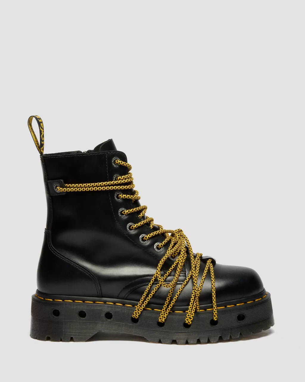 Black boot with gold laces on a light gray background