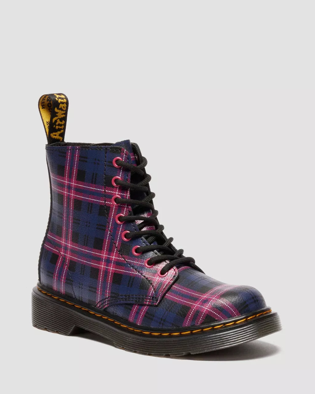 Plaid patterned boot with black laces on a light gray background