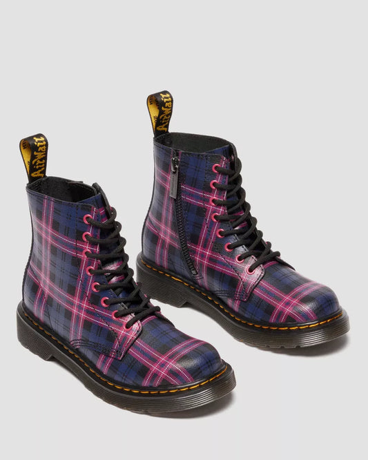 Plaid patterned boots with black soles on a light gray background