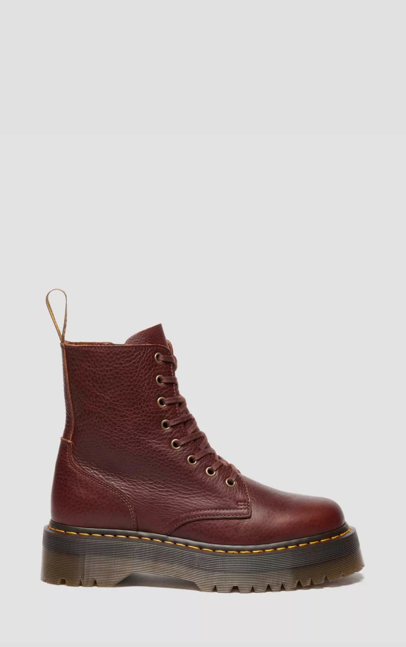 Brown leather boot with a white background