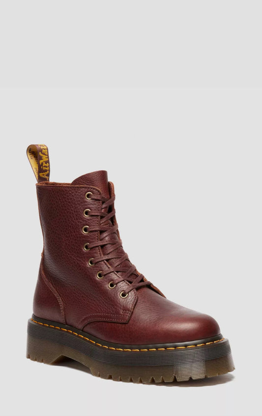 Brown leather boot with a white background