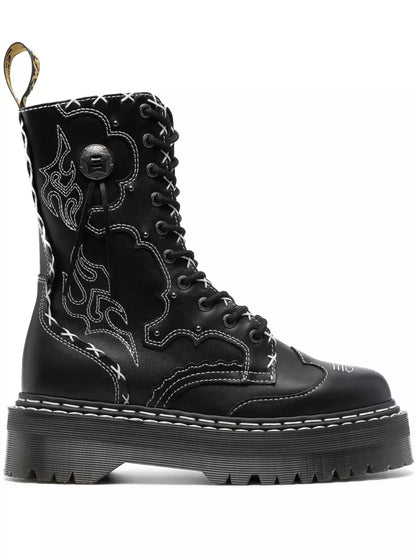 Black boot with intricate design on a white background