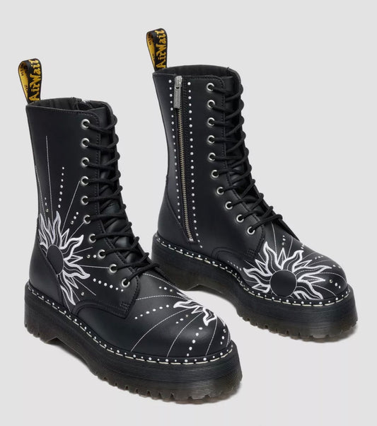 Black boots with white floral designs on a light gray background