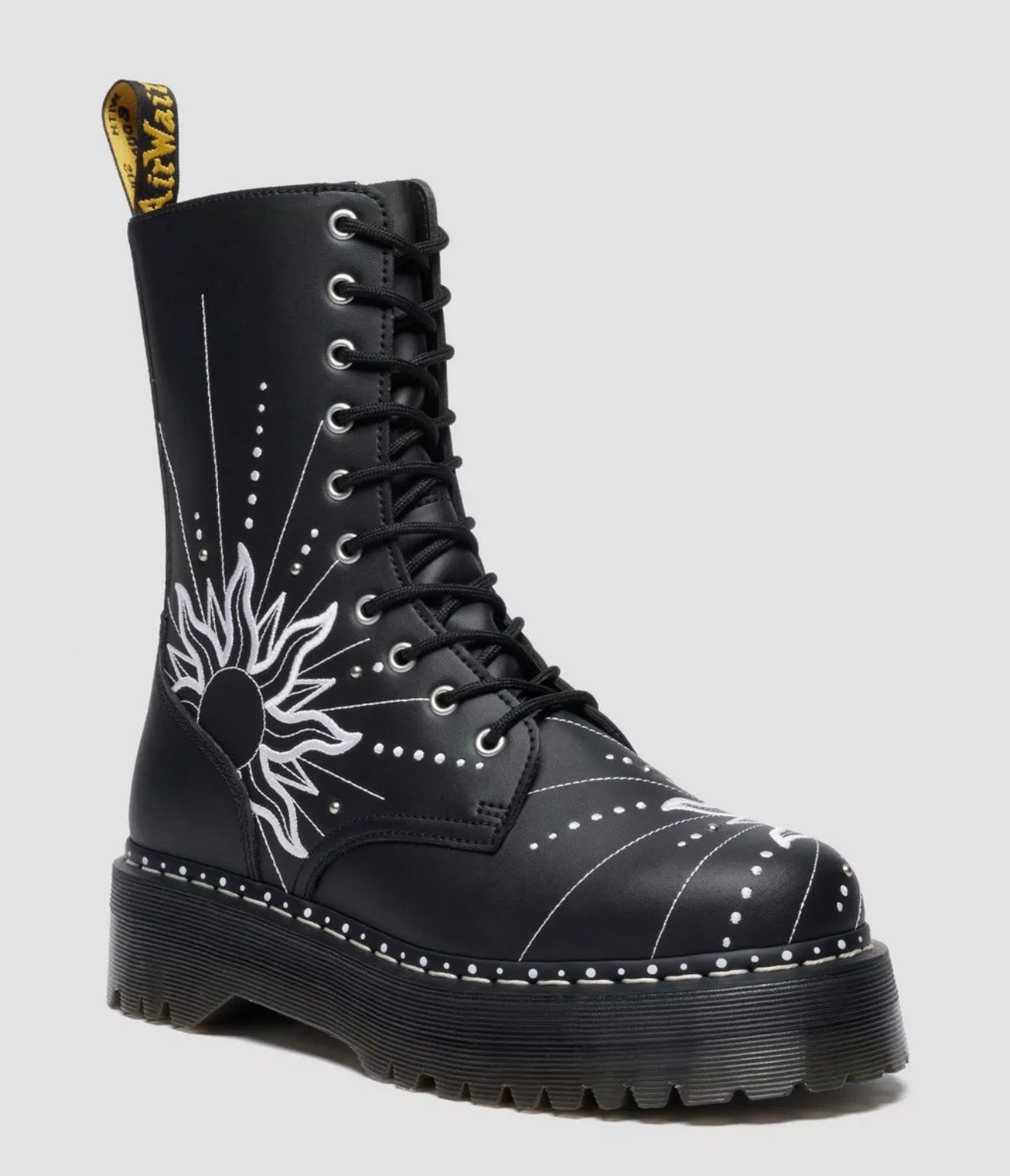 Black boot with white floral design on a gray background