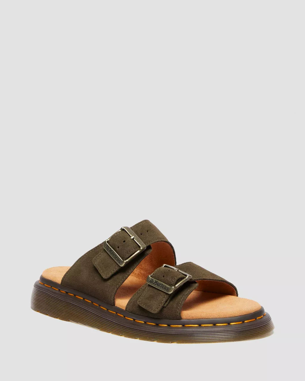 A pair of black suede slide sandals with buckle closures and a flat sole.