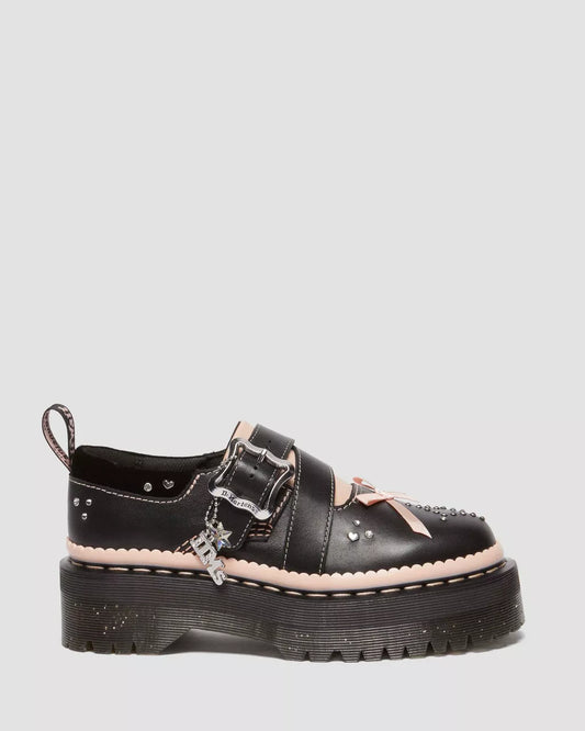A black platform shoe with silver buckle, pink accents, and a chunky sole.
