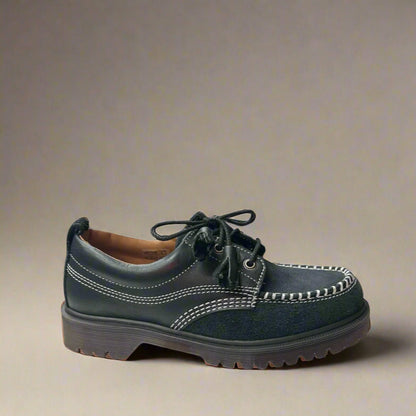 A single black suede Moc Toe shoe with a lace-up closure and a rubber sole.