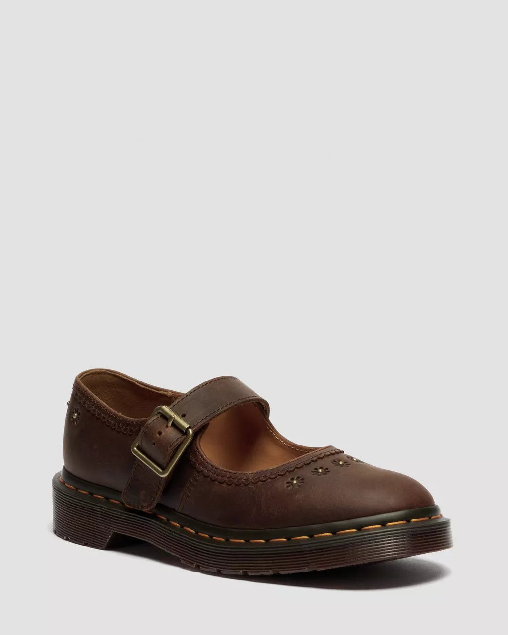 Brown leather shoe with a buckle on a light gray background