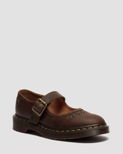 Brown leather shoe with a buckle on a light gray background