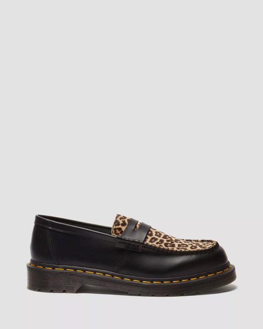 Black loafer with leopard print strap on a light gray background
