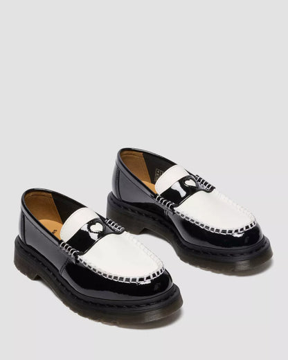 Black and white loafers on a light gray background