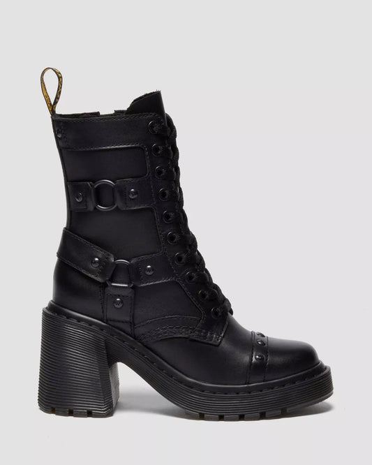 Black leather boot with buckles on a light gray background