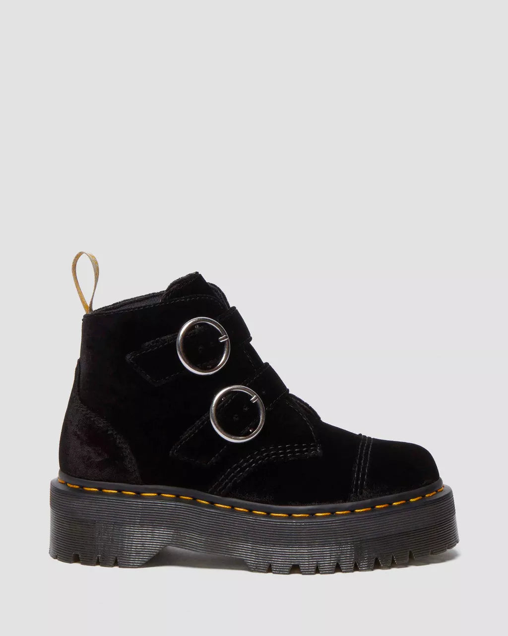 A pair of black velvet platform boots with a sturdy platform sole and two metal rings on the top.