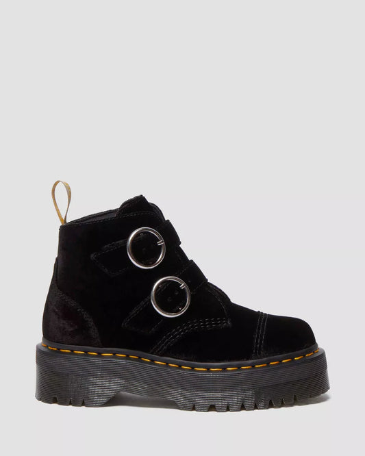 A pair of black velvet platform boots with a sturdy platform sole and two metal rings on the top.