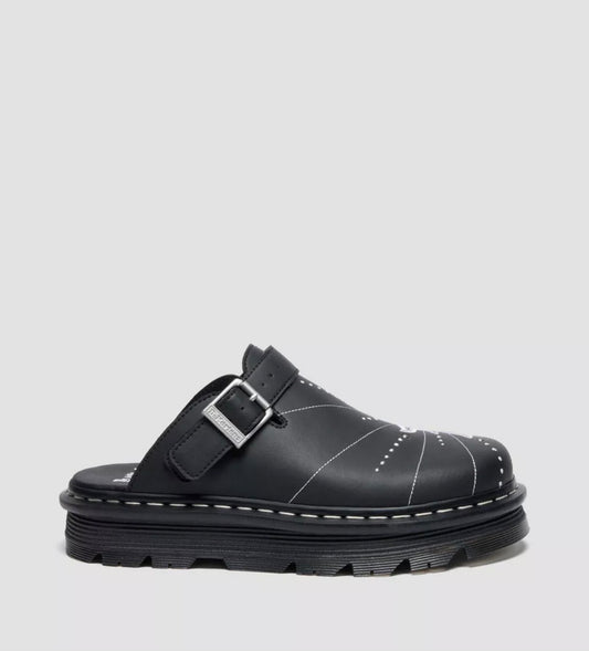 Black clog shoe with a buckle on a light gray background