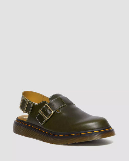 Green leather shoe with buckles on a light gray background
