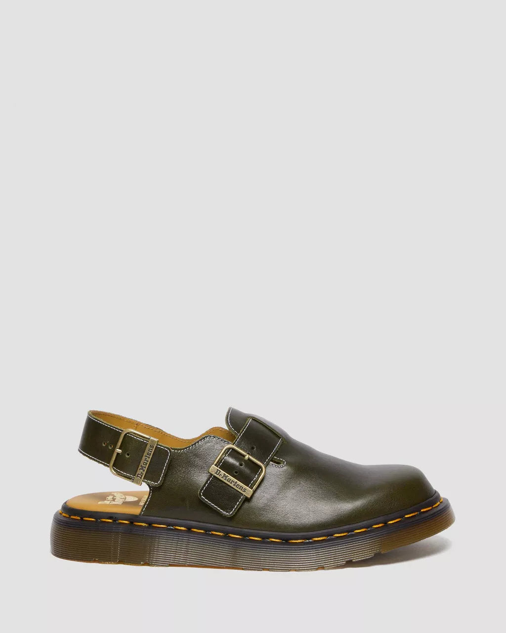 Green leather shoe with buckles on a light gray background