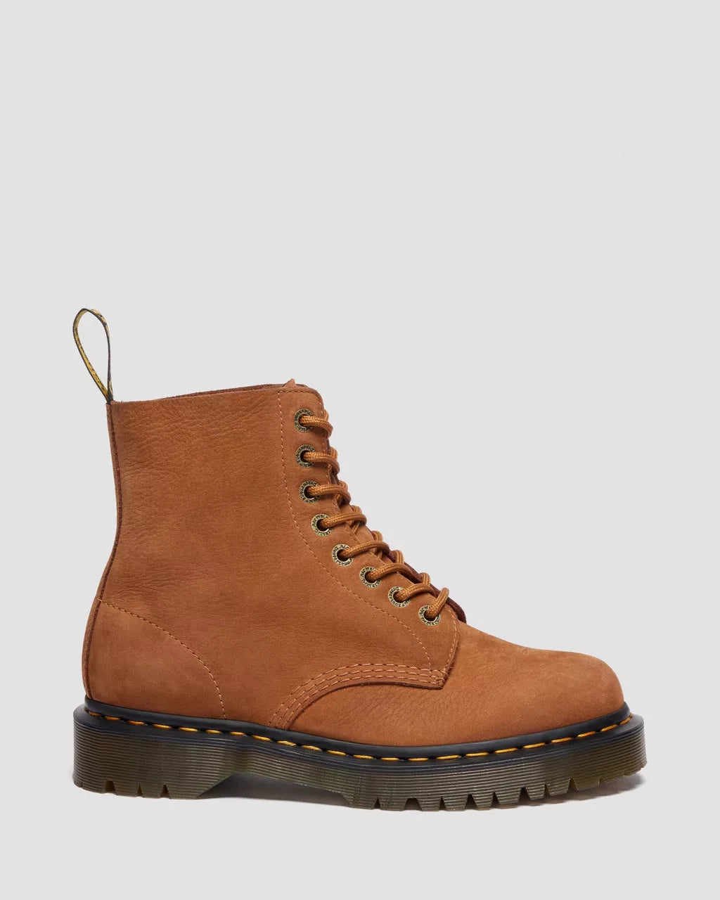 Brown leather boot with black sole on a light gray background