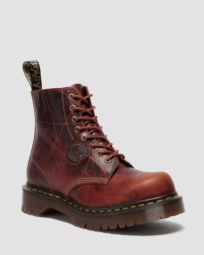 Brown leather boot with laces on a light gray background