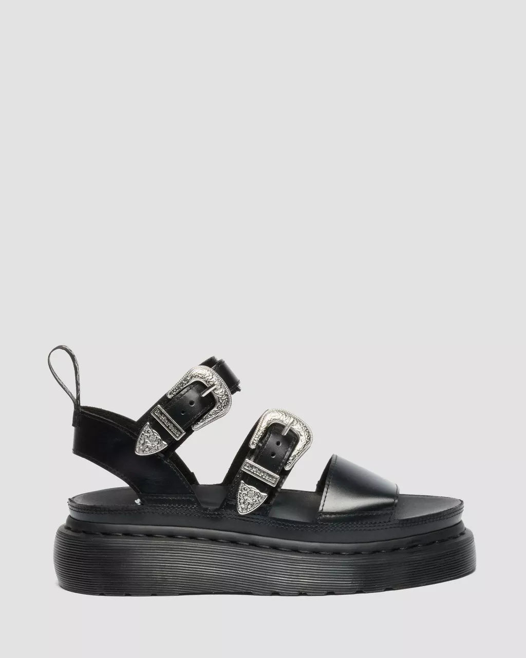 Black sandal with buckles on a light gray background
