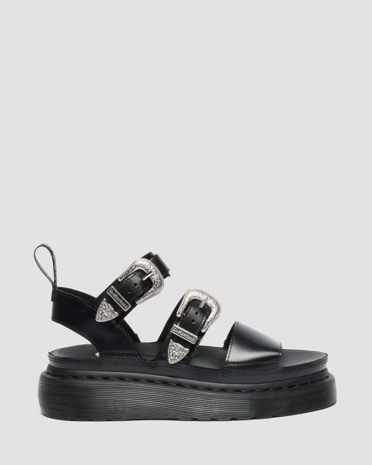 Black sandal with buckles on a light gray background