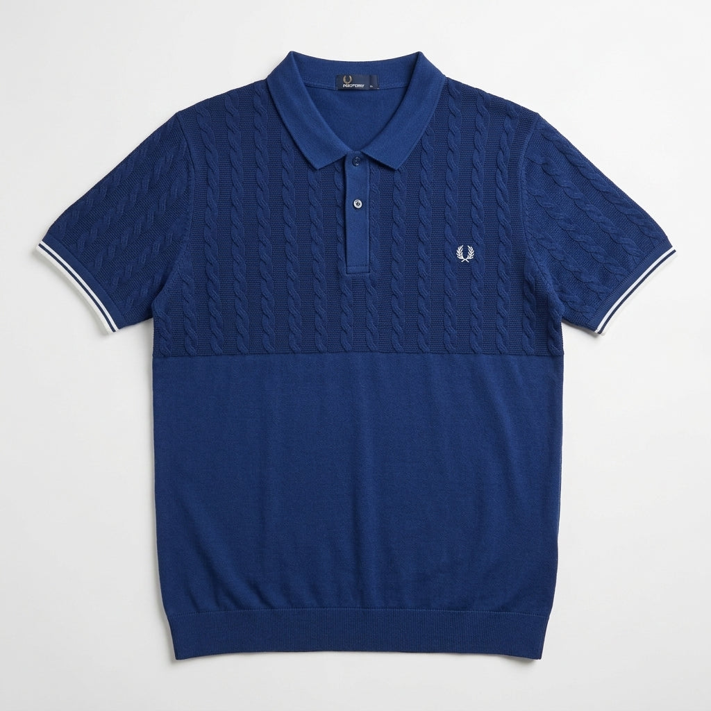 Fred Perry half panel cable blue polo shirt with cable knit pattern on a light gray background