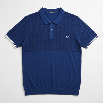 Fred Perry half panel cable blue polo shirt with cable knit pattern on a light gray background