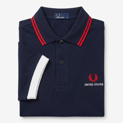 Fred Perry vintage world cup USA twin-tipped navy polo shirt with red and white accents and Fred Perry logo on a white background