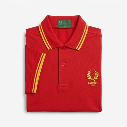 Fred Perry vintage world cup España 2010 twin-tipped red polo shirt with yellow accents and a logo on a white background