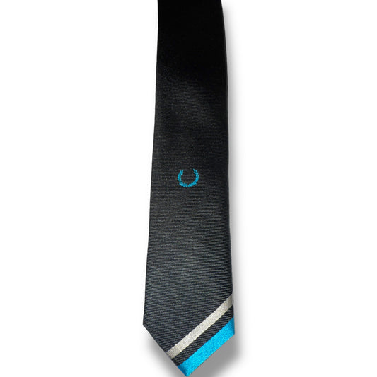 A black necktie with teal and silver tips lying flat on a surface.