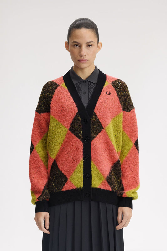 Person wearing a colorful patterned cardigan on a white background