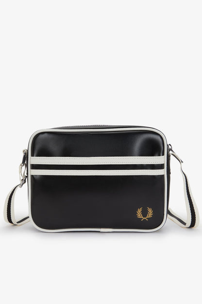 Black crossbody bag with white stripes and a brand logo on a white background