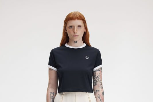 Person wearing a black t-shirt with a logo on a white background