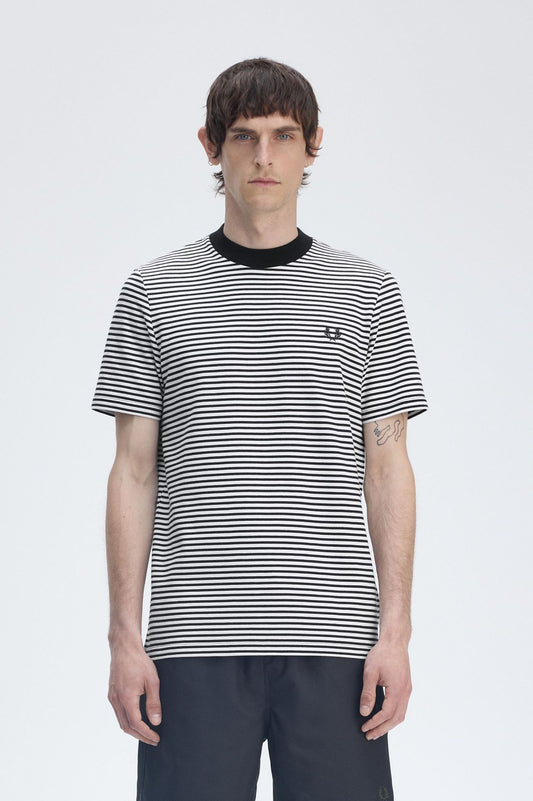 A man wearing a slim fit, black and white striped t-shirt with the Laurel Wreath logo on the left chest.