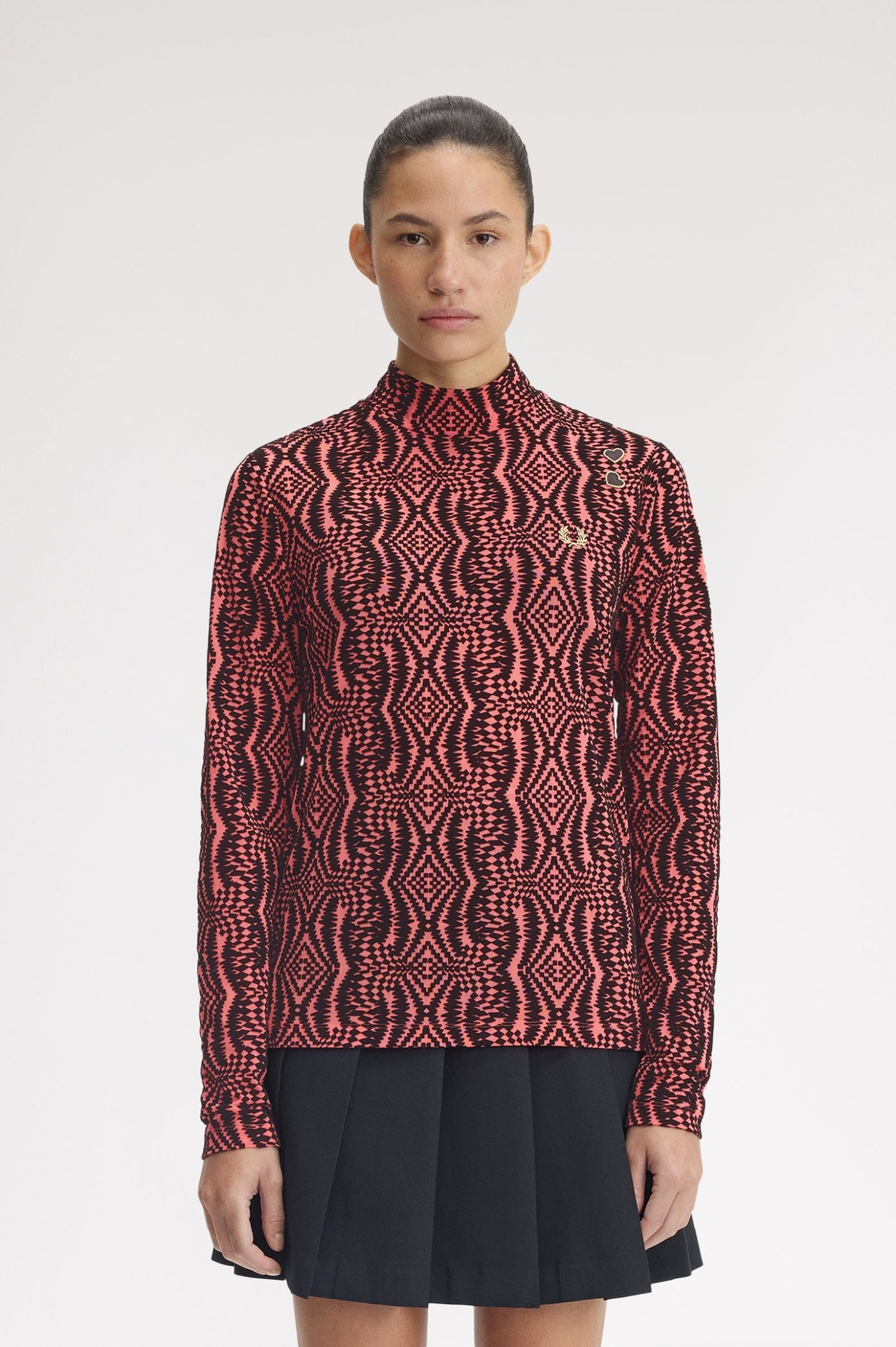 Person wearing a patterned red and black shirt with a white background